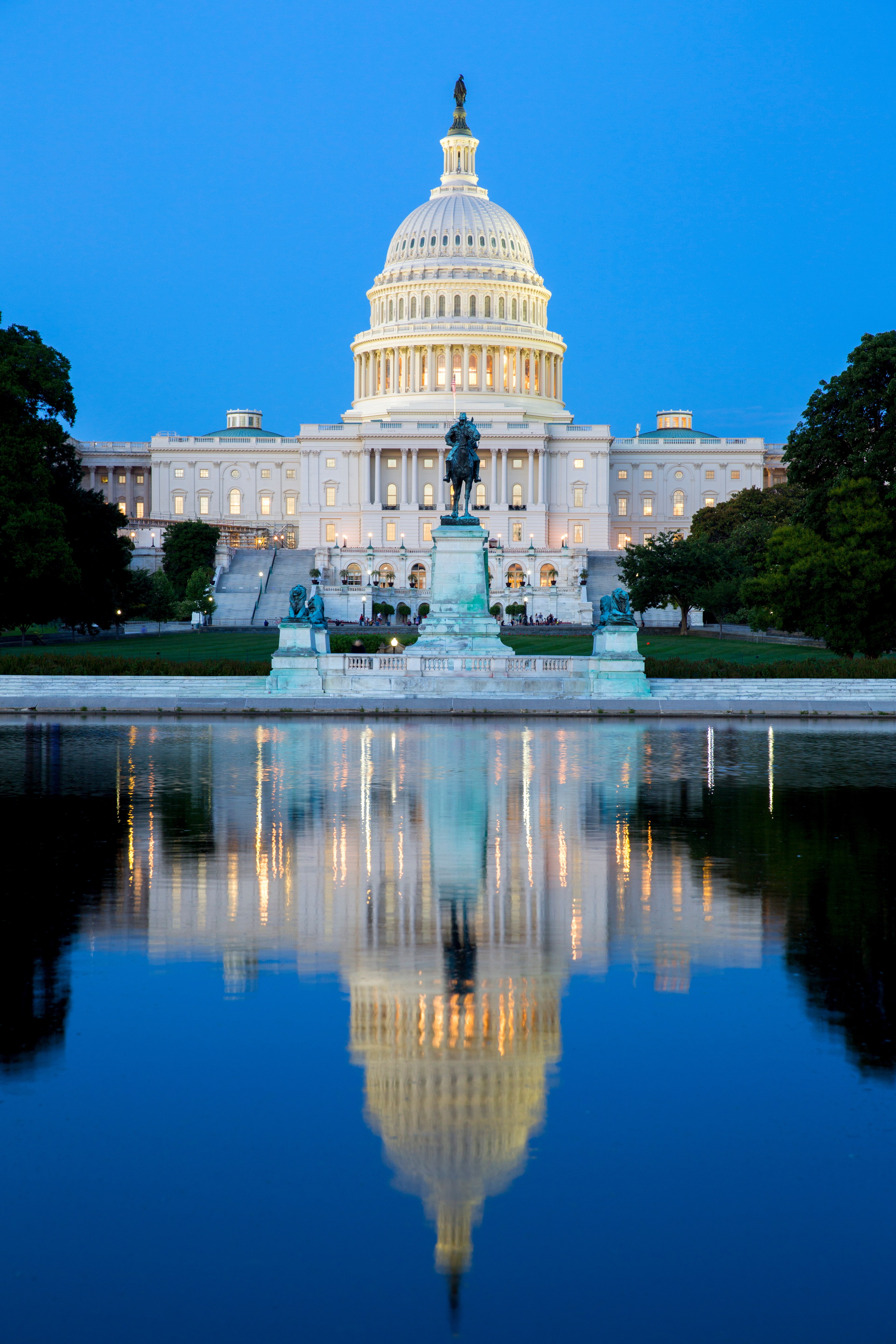 Capitol building in Washington illuminated at night.